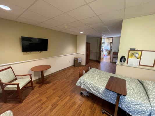 A private resident room with a bed and furnishings