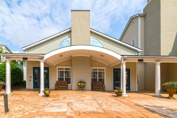 Main entrance of The Dorchester and Manor with benches and flower pots