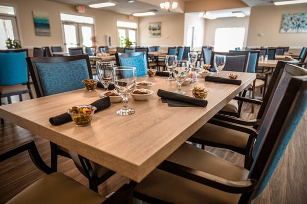 Dining table set with glasses and snack bowls