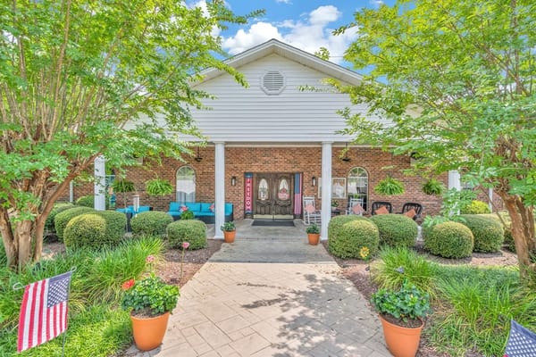 Building exterior entrance with summer decorations and landscaping