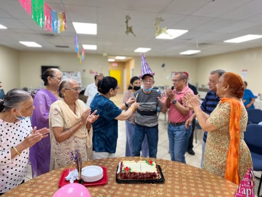 Residents celebrating a birthday with cake and decorations