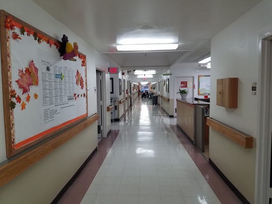 Bright hallway with art and decorations in a care facility