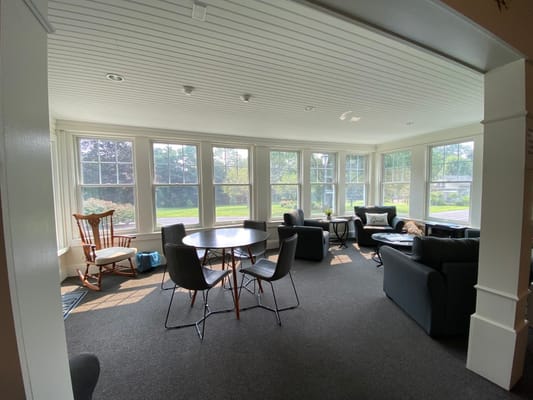 Bright common area with seating and natural light
