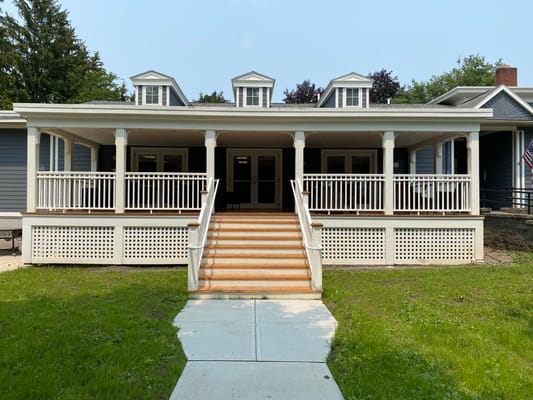 Front entrance of a senior living facility with a porch