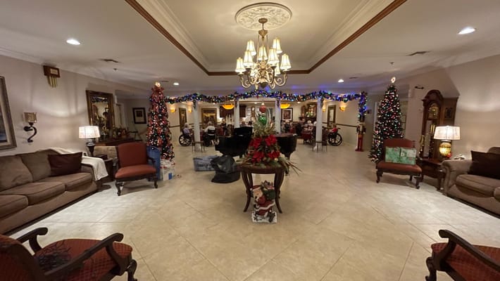 Lobby area decorated for the holidays with a Christmas tree and festive lights