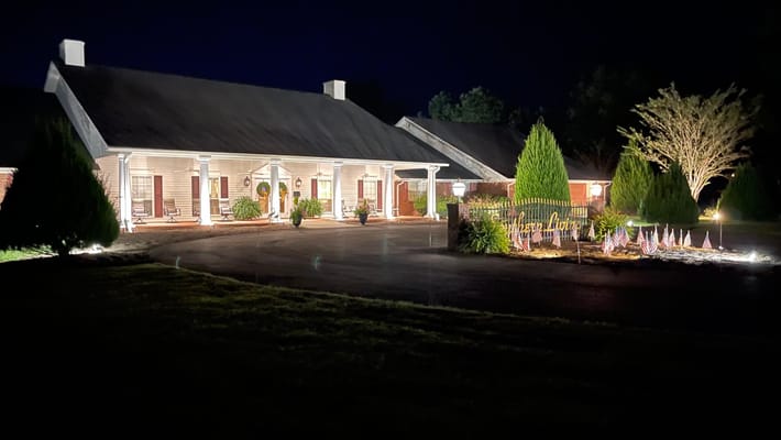 Exterior view of Southern Living Specialty Care illuminated at night