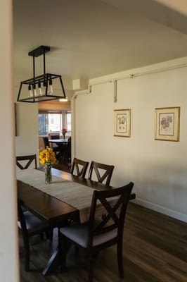 Bright dining room with a large table and flowers