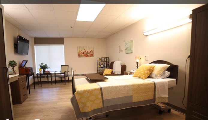 Cozy private room with a bed, seating, and decor