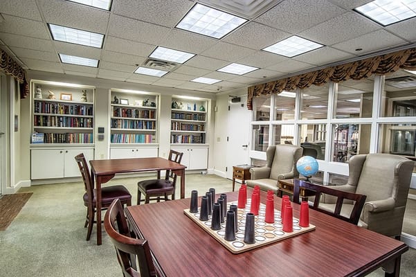 Common area with bookshelves and game tables