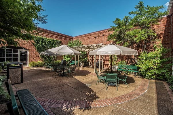 Outdoor seating area with tables and umbrellas