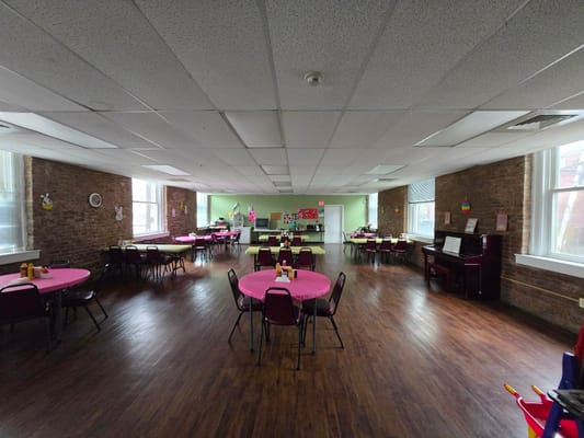 Bright activity room with tables and chairs