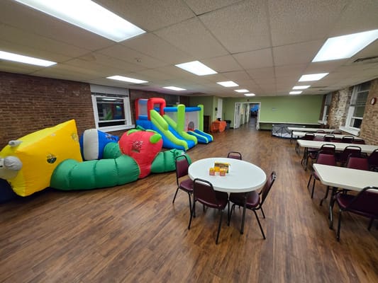 A bright activity room with inflatable equipment