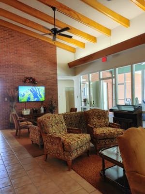 Lounge area with patterned chairs and a TV