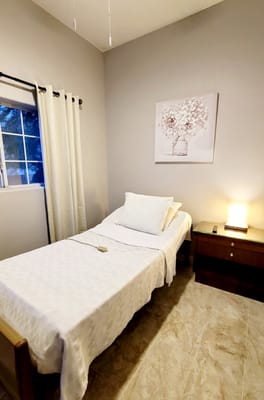 Simple, clean private resident room with a bed and decor
