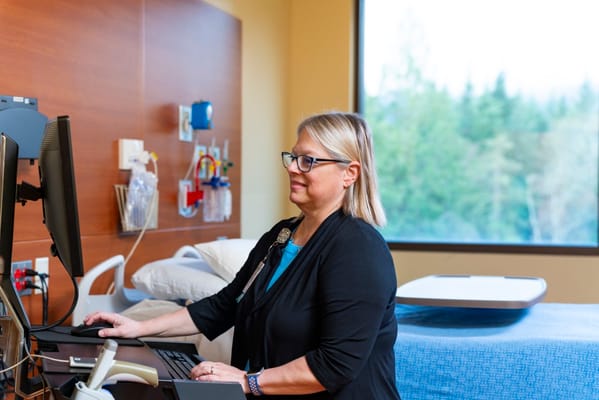 Staff member working at a computer in a care facility