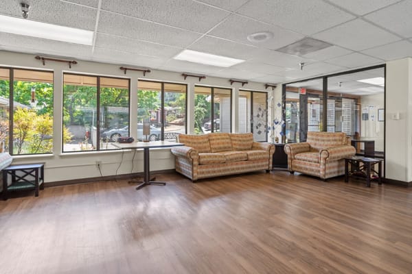 Bright common area with seating and large windows