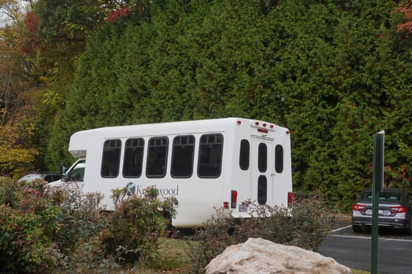 Facility transport shuttle parked outside