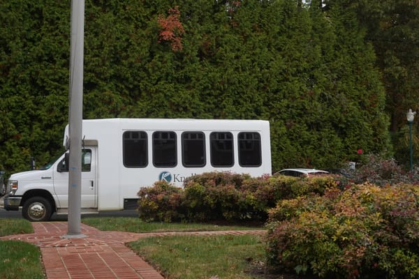 Facility transport vehicle in a landscaped area