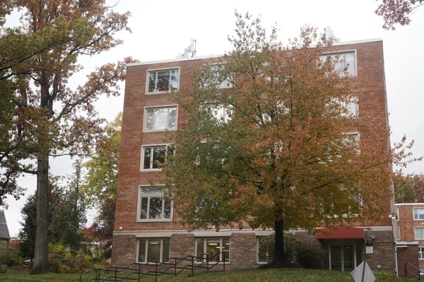 Exterior view of a senior living facility with seasonal foliage