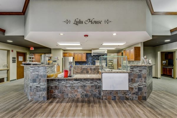 Interior view of Lulu House dining area with stone counter and kitchen in background