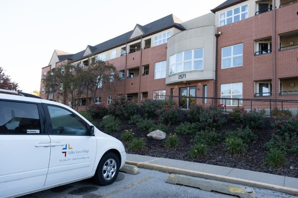 Exterior view of Valley View Village with parking and landscaping.