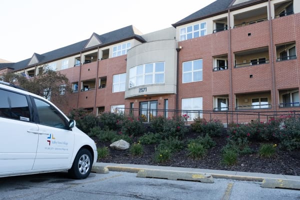 Exterior of Valley View Village with a parked van in front.