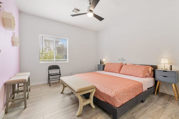 Stylishly furnished bedroom with a king-sized bed and natural light.