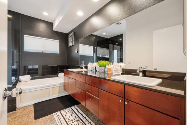 Modern bathroom with a tub and dual sinks
