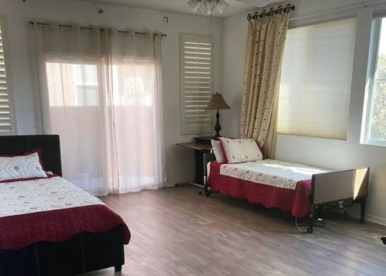 Bright and airy bedroom with two beds and a lamp