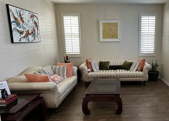 Inviting living room with cream sofas and decorative pillows