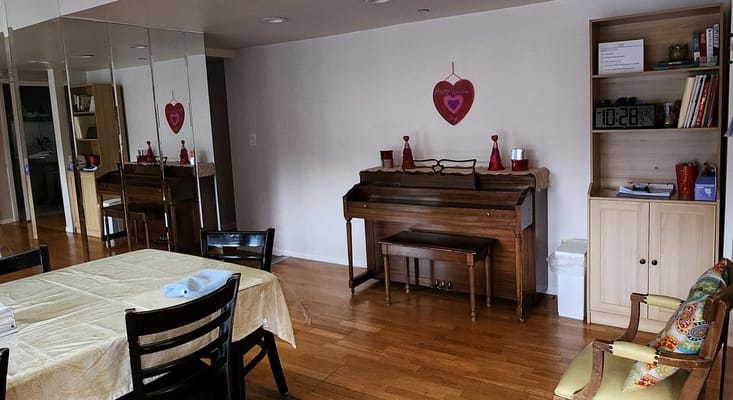 Common area with a piano and seating