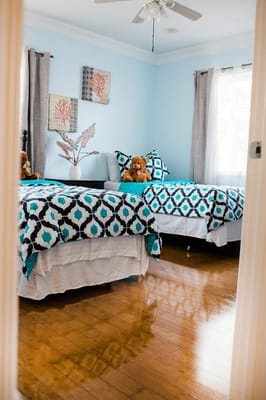 Cozy bedroom with two beds and decorated wall art