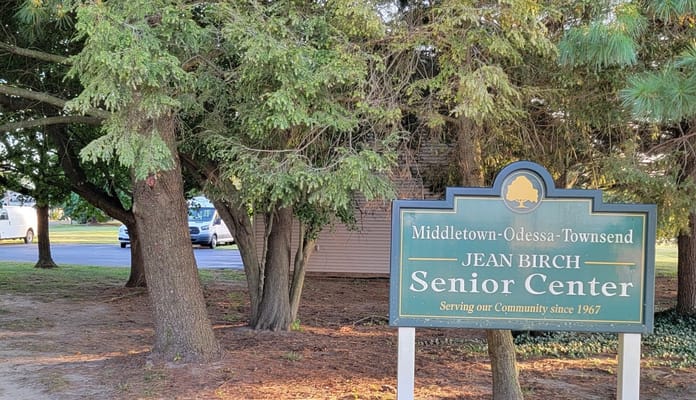 Exterior sign of Jean Birch Senior Center surrounded by trees
