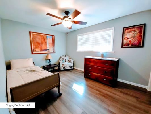 Cozy single bedroom with modern decor and lighting