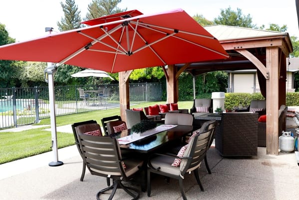 Outdoor seating area with umbrellas near a pool