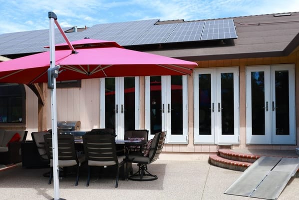Outdoor seating area with umbrellas and solar panels