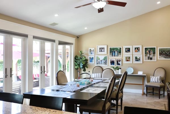 Bright common area with seating and framed photos