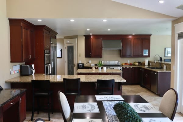Modern kitchen interior with dark wooden cabinets