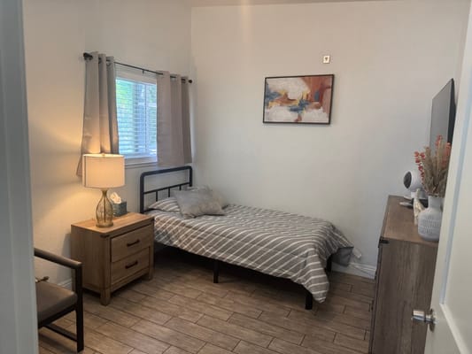 Private resident room with light decor and bed