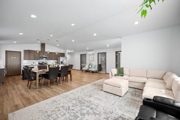 Bright and modern living area with dining table and sectional couch