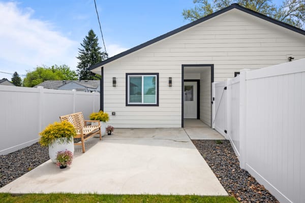 Front entrance of L&R Adult Family Home with seating area and plants