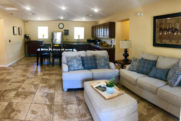 Bright common area with seating and kitchenette
