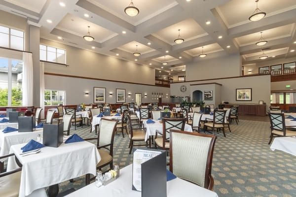 Spacious dining area with tables set for meals
