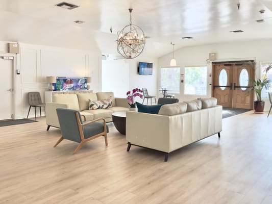 Spacious and inviting living room with seating and an aquarium