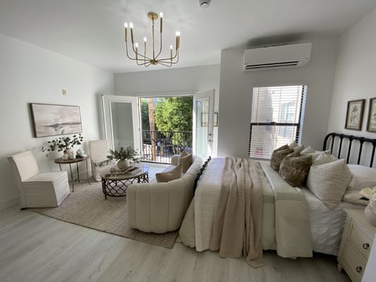 Bright, comfortable resident room with furniture and balcony access