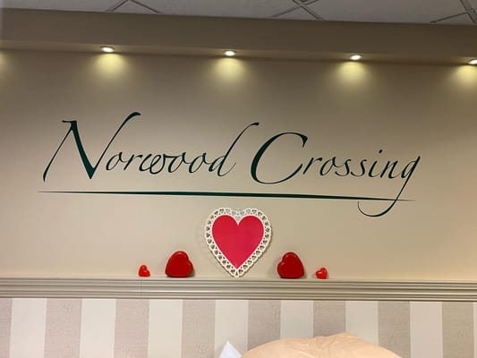 Decorative wall with facility name and heart decorations