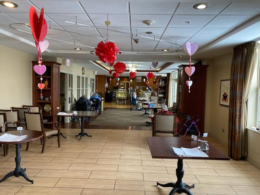 Decorated common area with residents engaged in activities