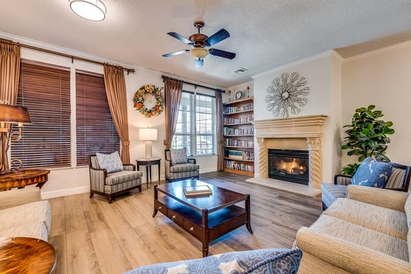 Cozy interior of a common area with fireplace and bookshelves