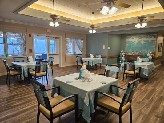 Dining area set up for an event with blue decor
