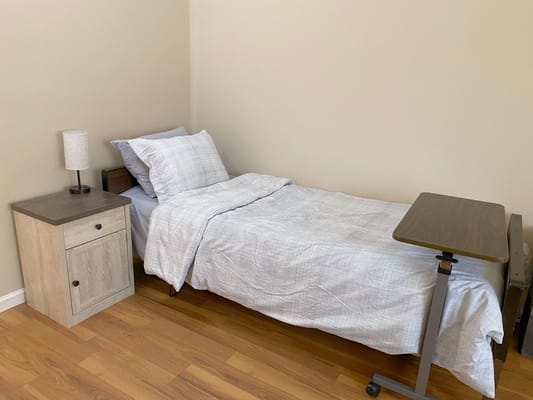 A single bed in a private resident room